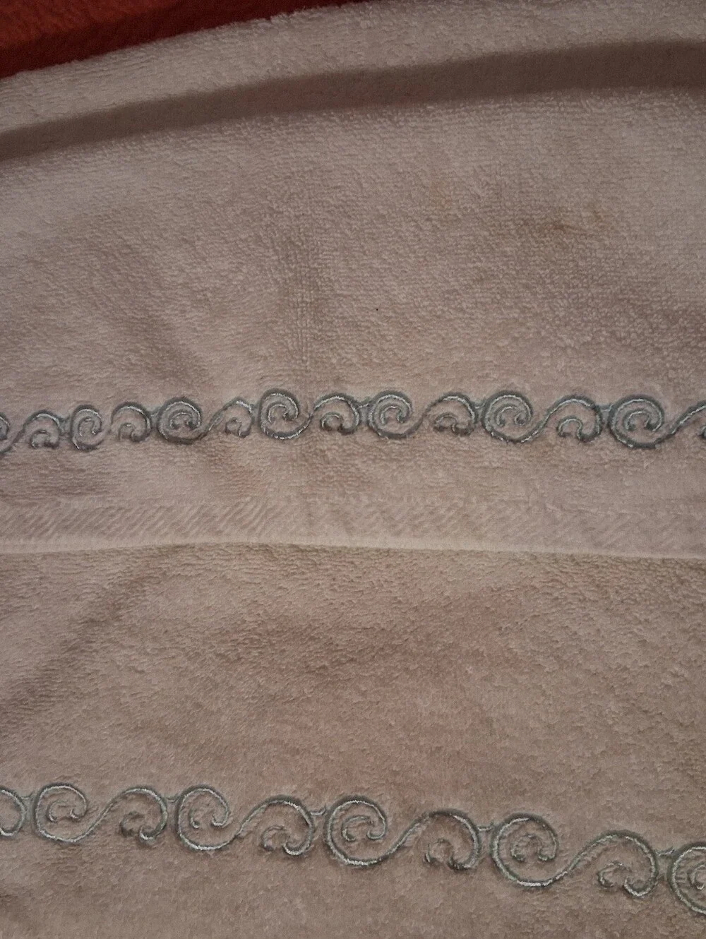 Hand Towel And Wash Cloth With Teal Design On It